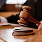 Merely moving hand over back and head of minor girl without sexual intent does not amount to ___
